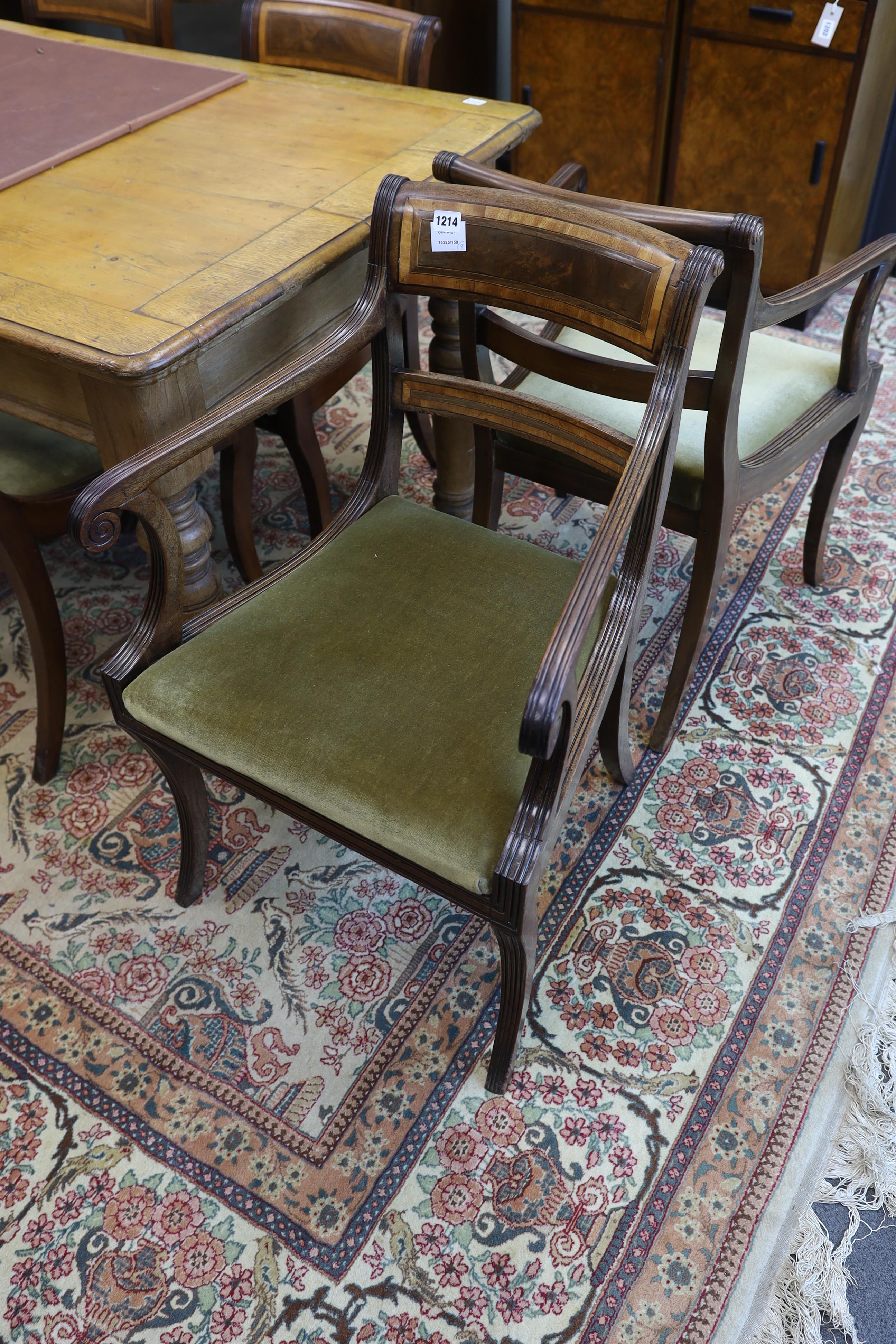 A set of eight Regency mahogany and satinwood banded sabre leg dining chairs, two with arms